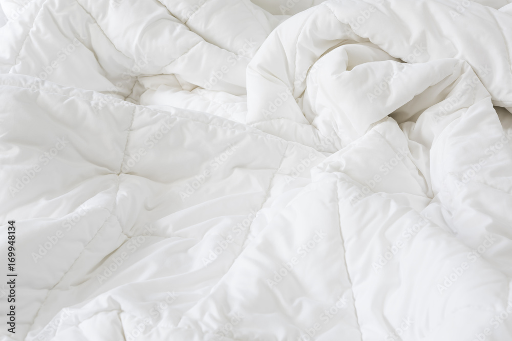 Close up messy white sheet and pillows on bed bedroom interior