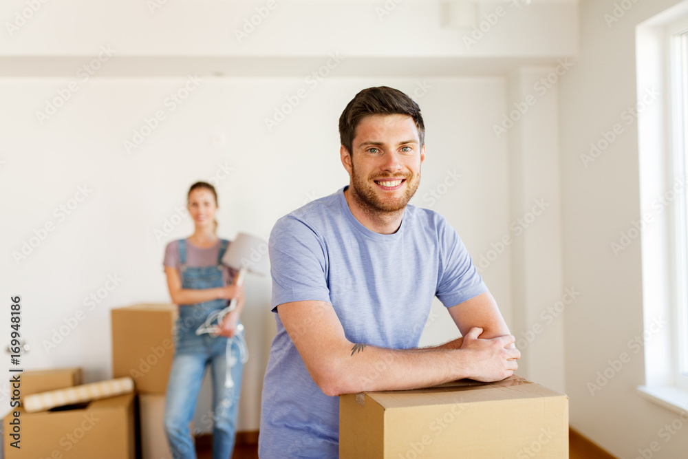 happy couple with boxes moving to new home happy couple with boxes moving to new home
