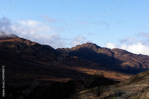 the morning sun creeping over the mountains along the West Highland Way