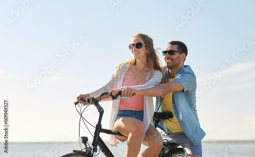 happy young couple riding bicycles at seaside © Syda Productions