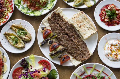 Adana Kebab; healthy and fresh salad varieties and appetizer on wooden table