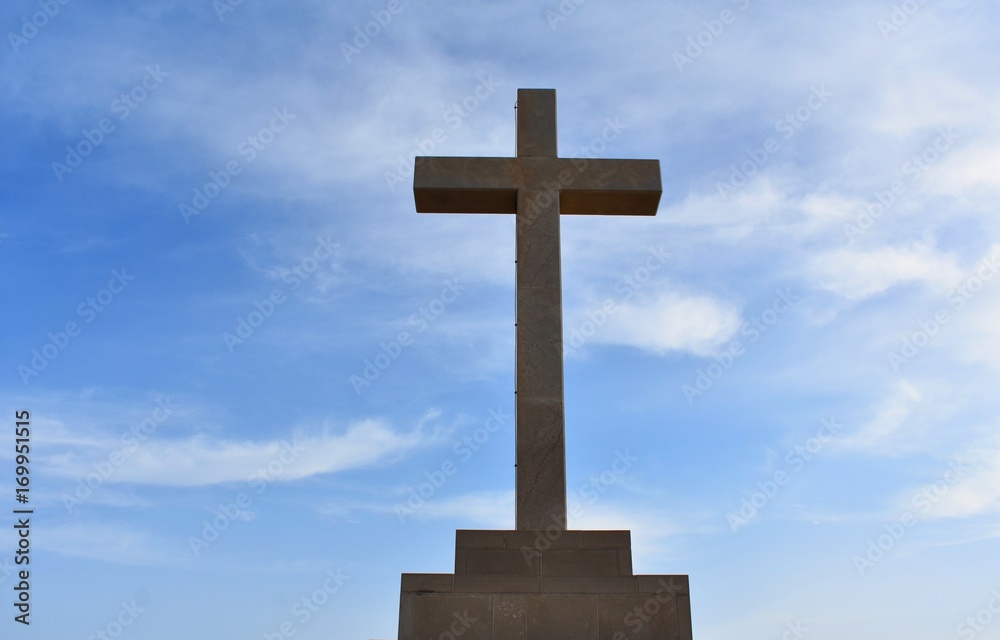 big stone cross sky on background 