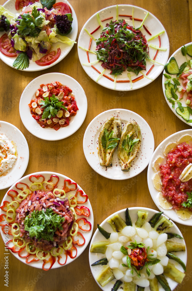 healthy and fresh salad varieties and mezes on wooden table