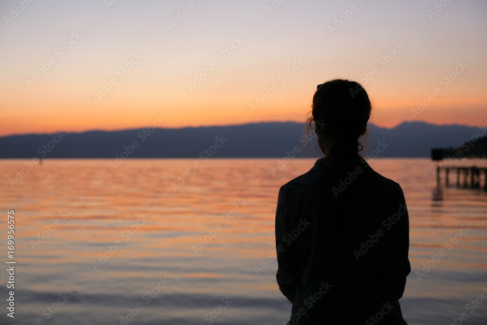Silhouette of young woman on beach sunset. Silhouette of young woman on beach sunset.