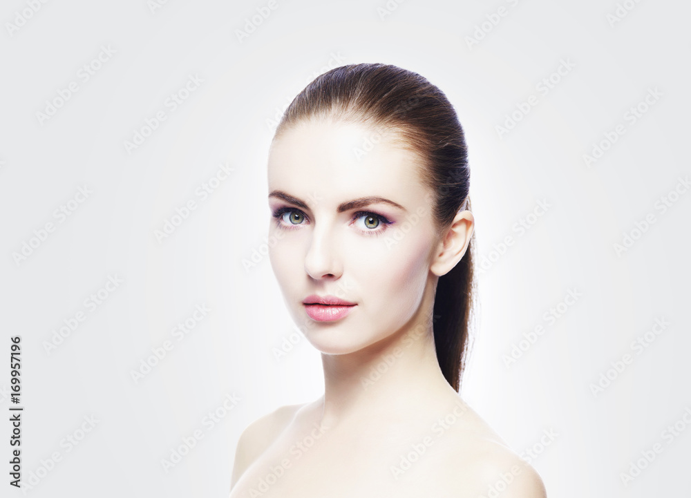 Obraz premium Portrait of young, beautiful and healthy woman: over cold grey background. Healthcare, spa, makeup and face lifting concept.