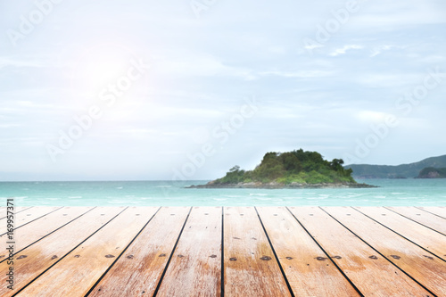 old wood table top on blurred beach background with coconut leaf. Concept Summer, Beach, Sea, Relax.