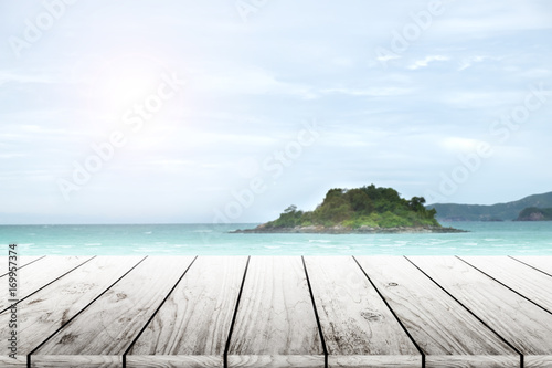 old wood table top on blurred beach background with coconut leaf. Concept Summer  Beach  Sea  Relax.