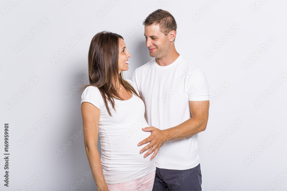 caucasian couple expecting baby smiling cheerful on white caucasian couple expecting baby smiling cheerful on white