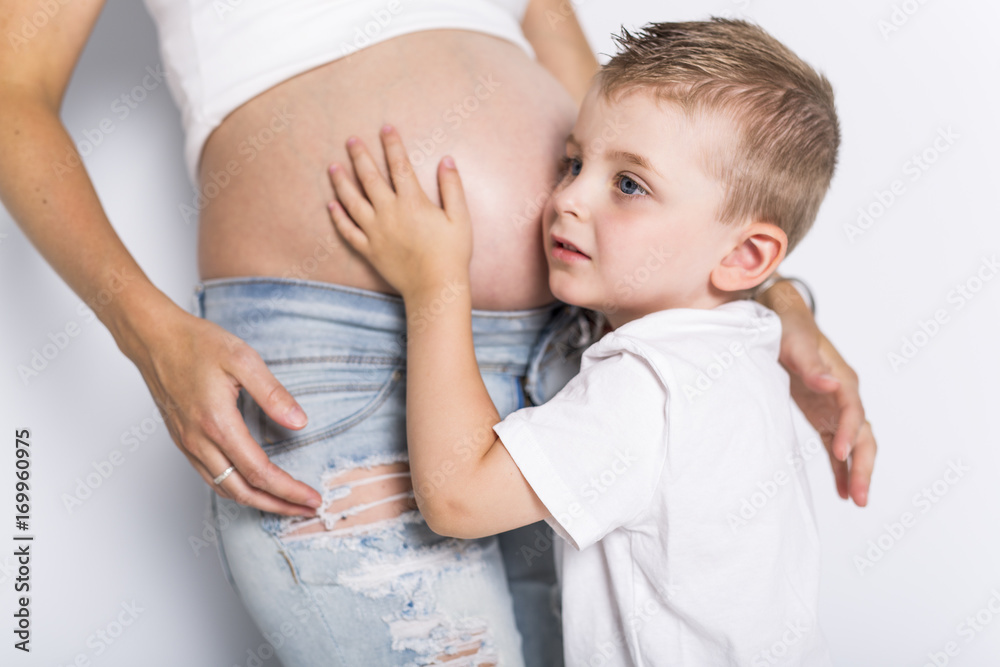 Young boy with the pregnant woman isolated on white background Young boy with the pregnant woman isolated on white background