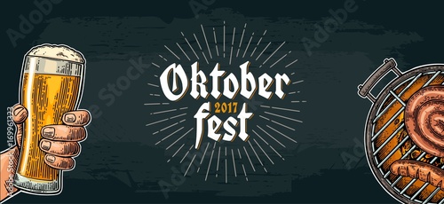 Male hand holding beer glass and Barbecue grill. Oktoberfest festival.