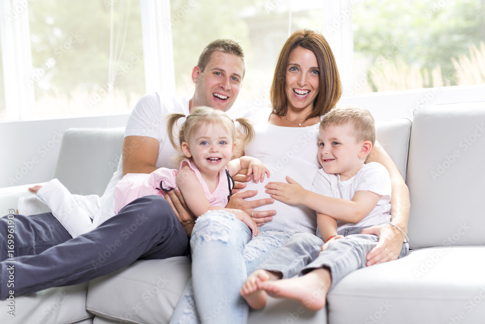 Beautiful family portrait sitting in the living room at home