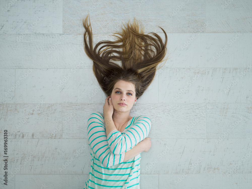 Fototapeta premium beautiful girl lying on floor