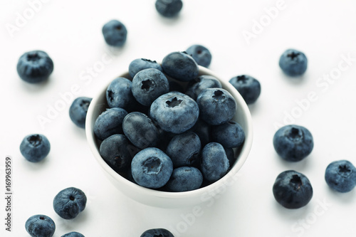 Blueberries in a white ceramic bowl  closeup shot