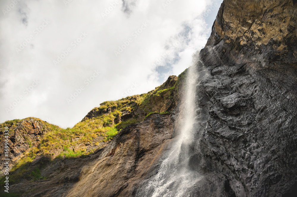 Obraz premium Caucasian waterfall high in the mountains