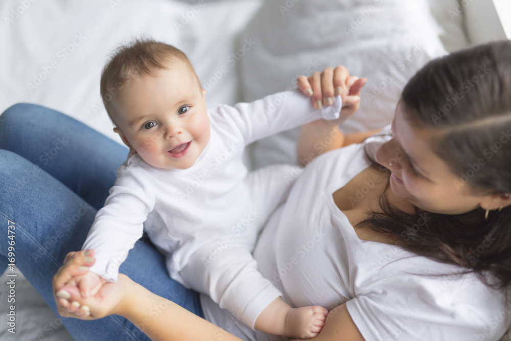 happy loving family. mother playing with her baby in the bedroom. happy loving family. mother playing with her baby in the bedroom.