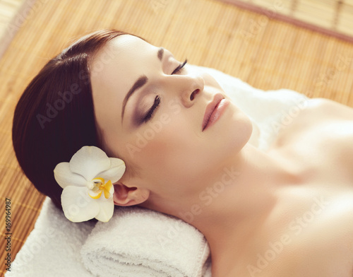 Young and healthy woman getting spa treatment in massaging salon. Health care, rejuvenation and relaxation concept.