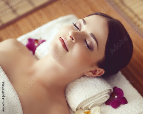 Young and healthy woman getting spa treatment in massaging salon. Health care, rejuvenation and relaxation concept.
