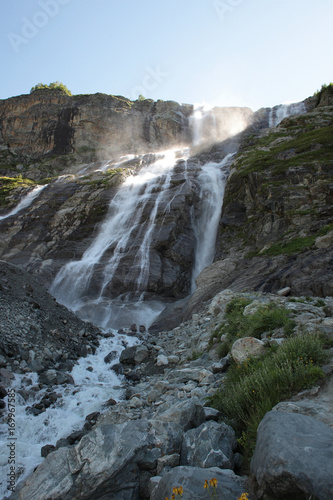 Beautiful high wide mountain waterfall with stones