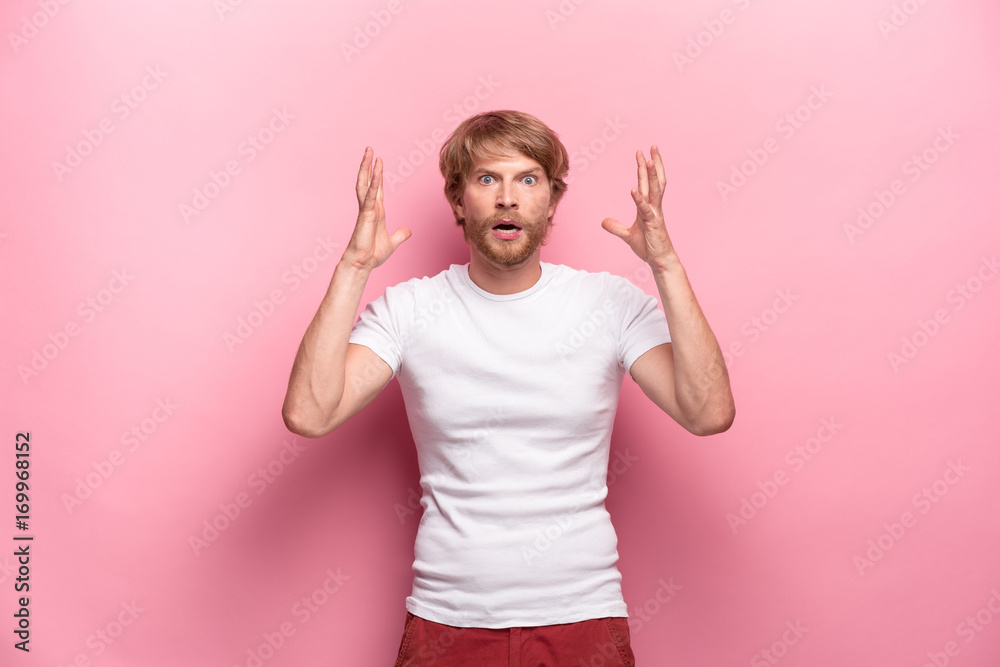 Portrait of young man with shocked facial expression Portrait of young man with shocked facial expression