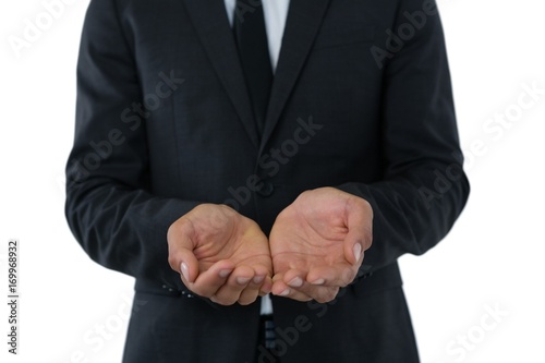 Mid section of businessman with hands cupped
