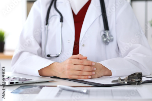 Close up of a unknown female doctor's hands. Physician is ready to consult and halp patients