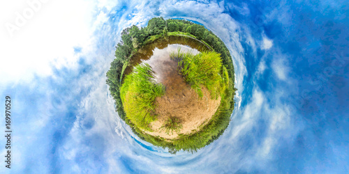 Fototapeta Naklejka Na Ścianę i Meble -  Little planet with river, forest and blue sky. Planet Earth.