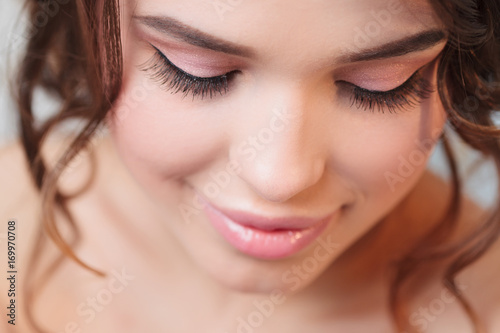 Attractive girl with beautiful eyelashes. Close-up