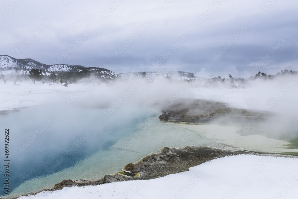 Obraz premium Steam Rising from Hot Spring in Winter