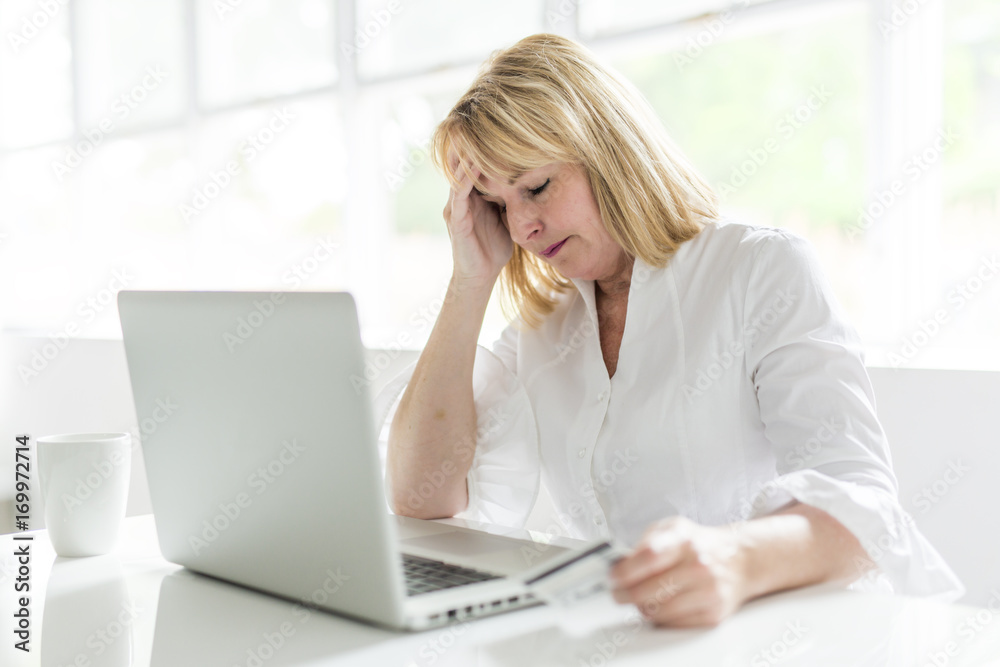 mature woman using laptop at home mature woman using laptop at home