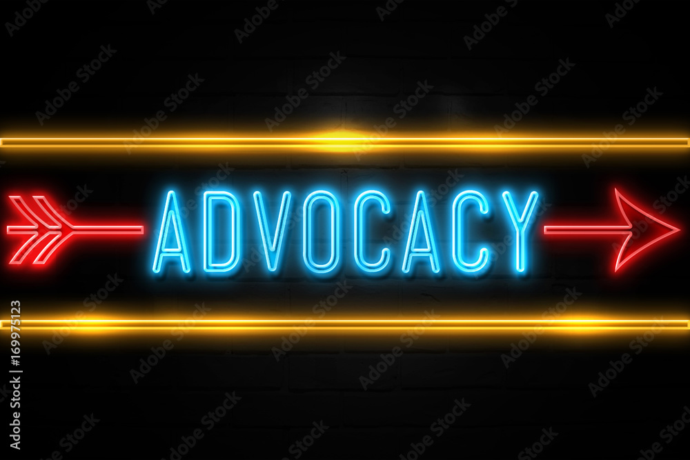 Advocacy  - fluorescent Neon Sign on brickwall Front view