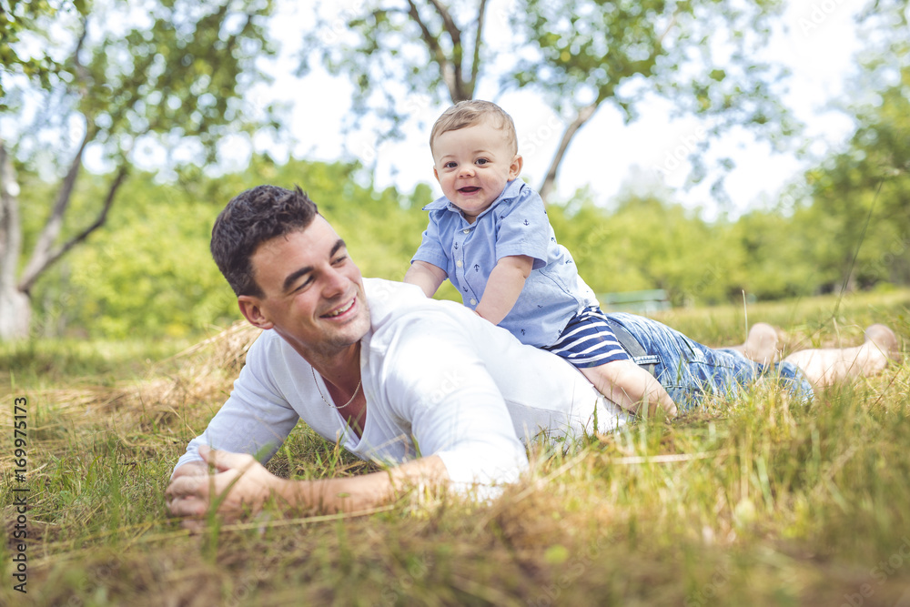 beautiful father little toddler son on the meadow. beautiful father little toddler son on the meadow.
