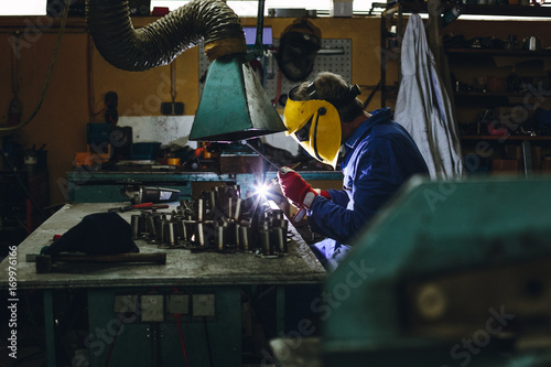 locksmith welding aluminium in his workshop