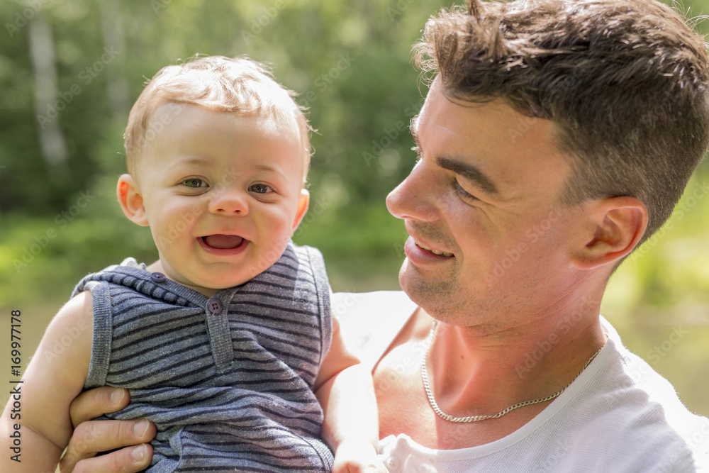 Fototapeta premium beautiful father little toddler son on the meadow.