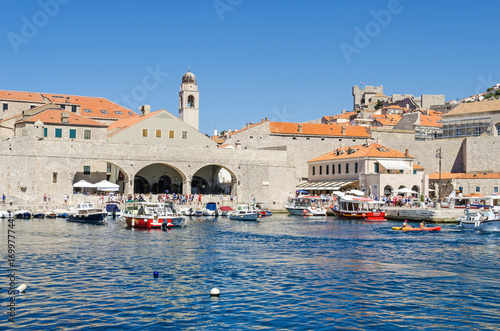 Old Harbour at Dubrovnik filled with tourists and boats of all sorts
