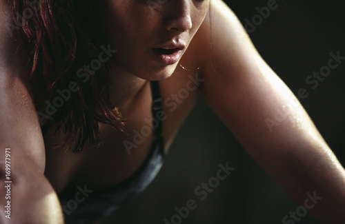 Active, fit mixed race woman training hard on box jumps in worko