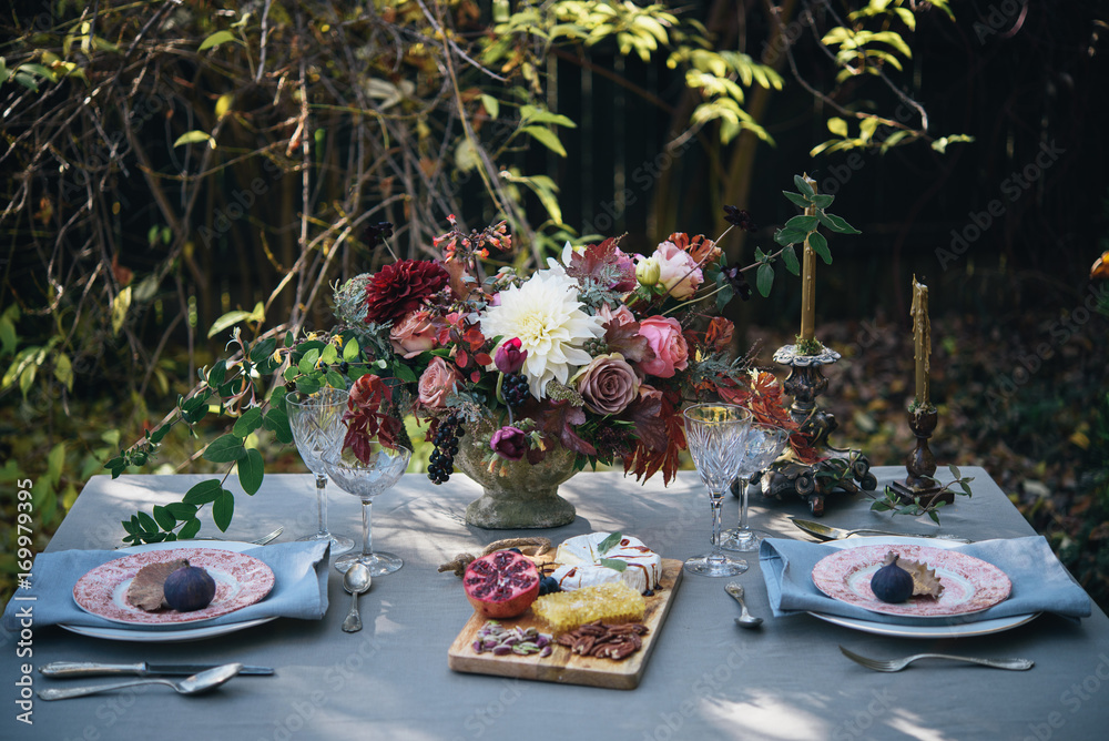 Autumn table set up in nature; Autumn flowers table for two Autumn table set up in nature; Autumn flowers table for two