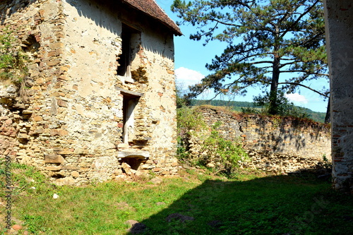 Ruins. Fortified medieval saxon evangelic church in the village Felmer, Felmern, Transylvania, Romania. The settlement was founded by the Saxon colonists in the middle of the 12th century photo