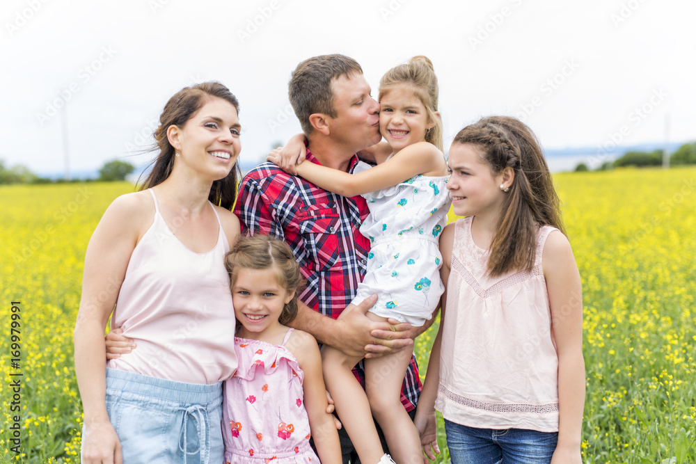 Family outdoors on a yellow field