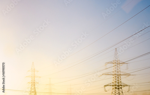 High-voltage power line in the fog at dawn