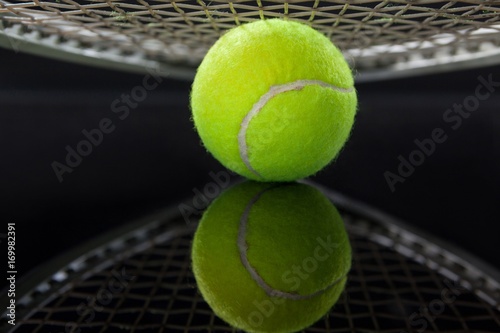 Close up of racket over tennis ball with reflection © WavebreakMediaMicro