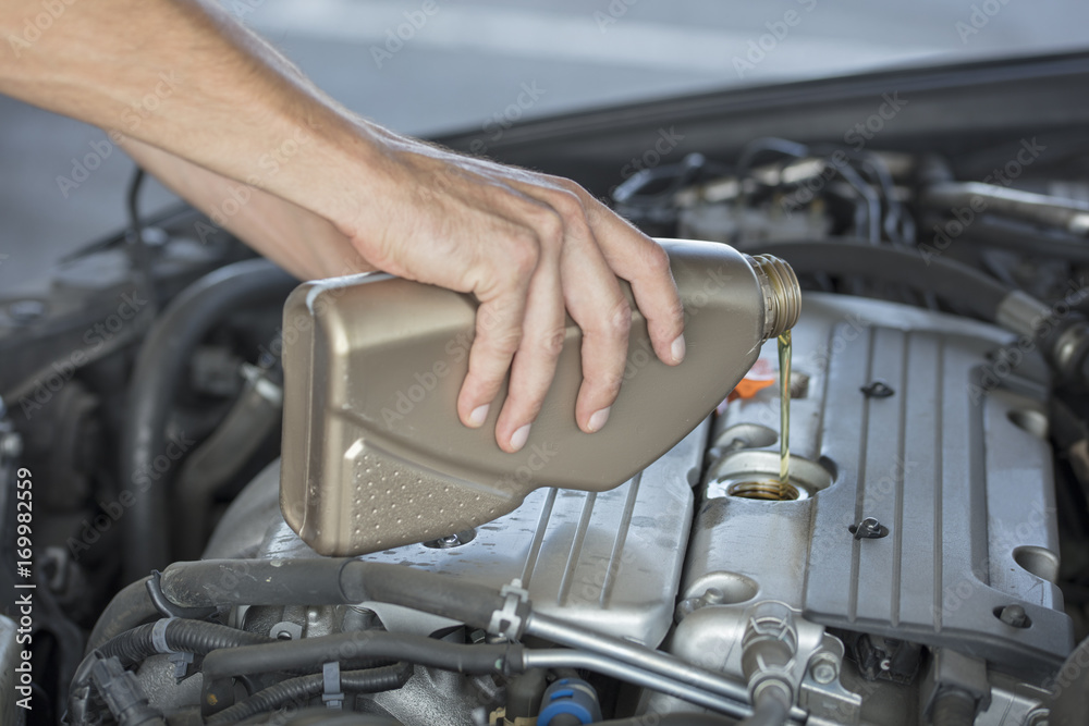 Adding car engine, motor oil level. Adding car engine, motor oil level.