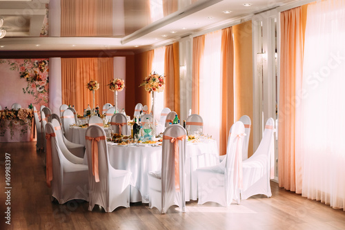 Decorative White Mantles And Colored Ribbons On Chairs At Festive Table