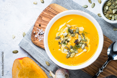 Pumpkin and carrot cream soup. Top view copy space. photo