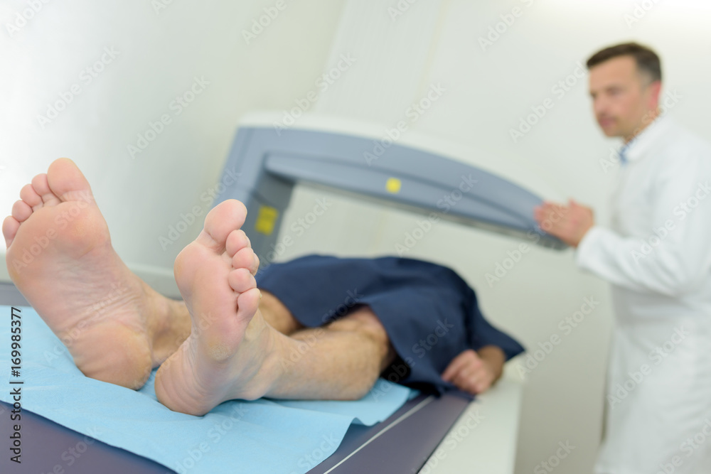 man going through ct scan in hospital man going through ct scan in hospital