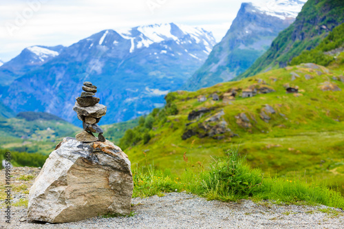 Stone stack and snowy mountain tops, Norway © Voyagerix