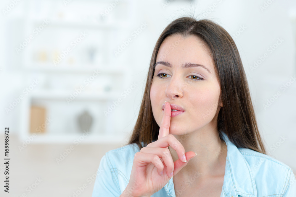 female nurse placing finger on lips female nurse placing finger on lips