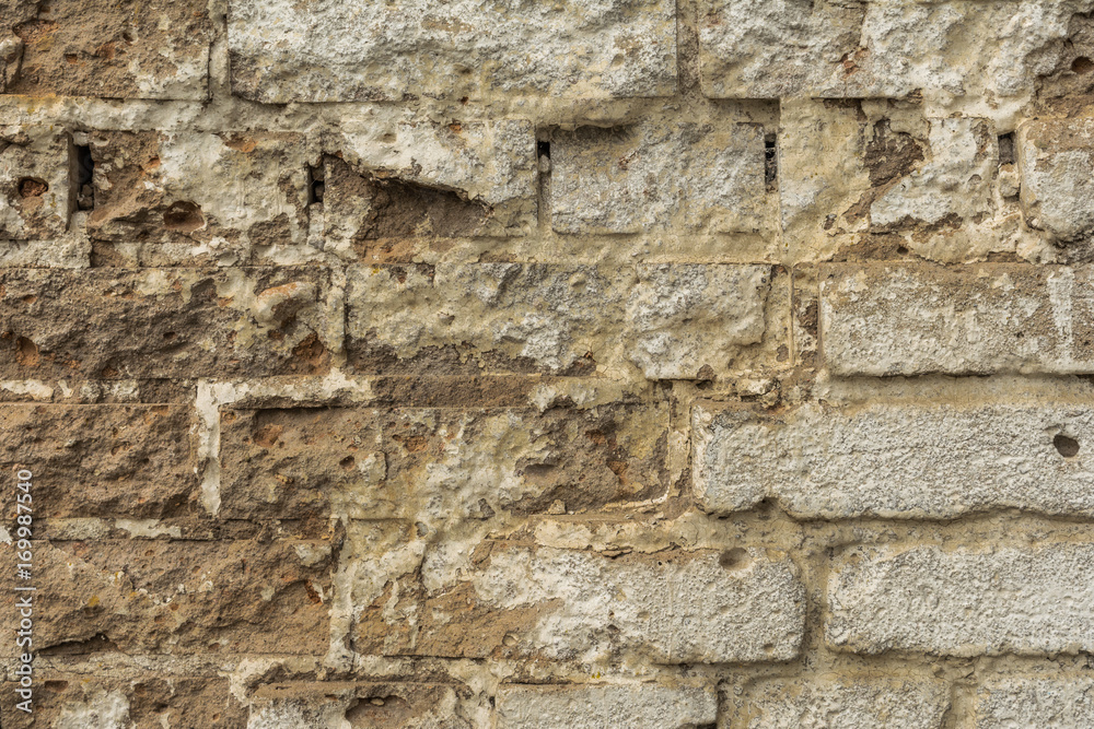 texture of an old ruined brick wall of an ancient building