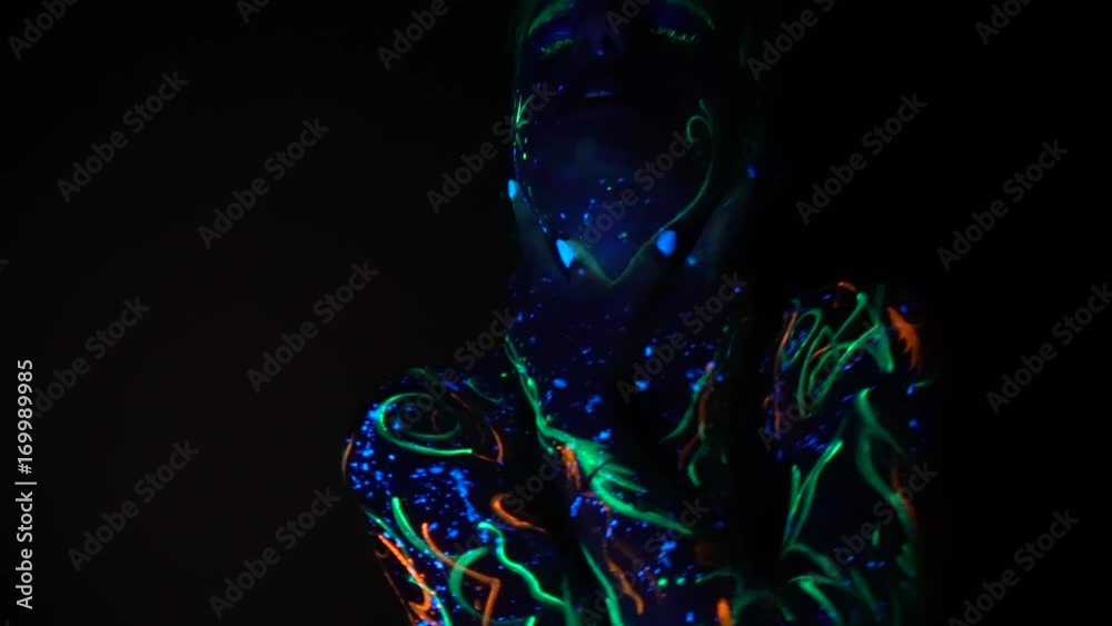 A girl painted with fluorescent paint grabs her neck and strangles herself in the dark A girl painted with fluorescent paint grabs her neck and strangles herself in the dark