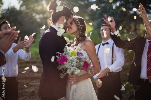 Obraz na plátně Affectionate bride and groom kissing on their wedding day