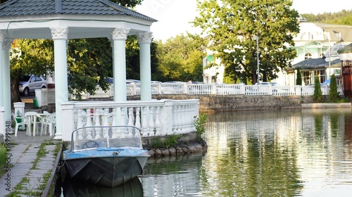 Motor boat at the pier on the lake in the city park of Nalchik. photo